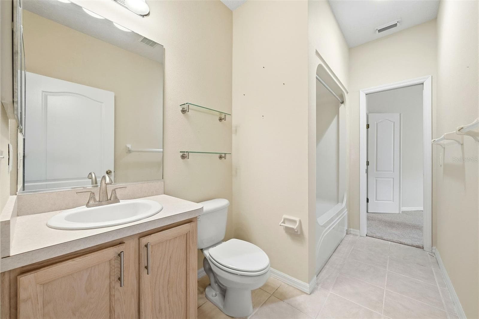 Guest Bath with tub/shower combination and one door to hallway next to Bedroom 2 and one door to office/den or possibly third bedroom suite - 2311 N ANDREA PT, LECANTO