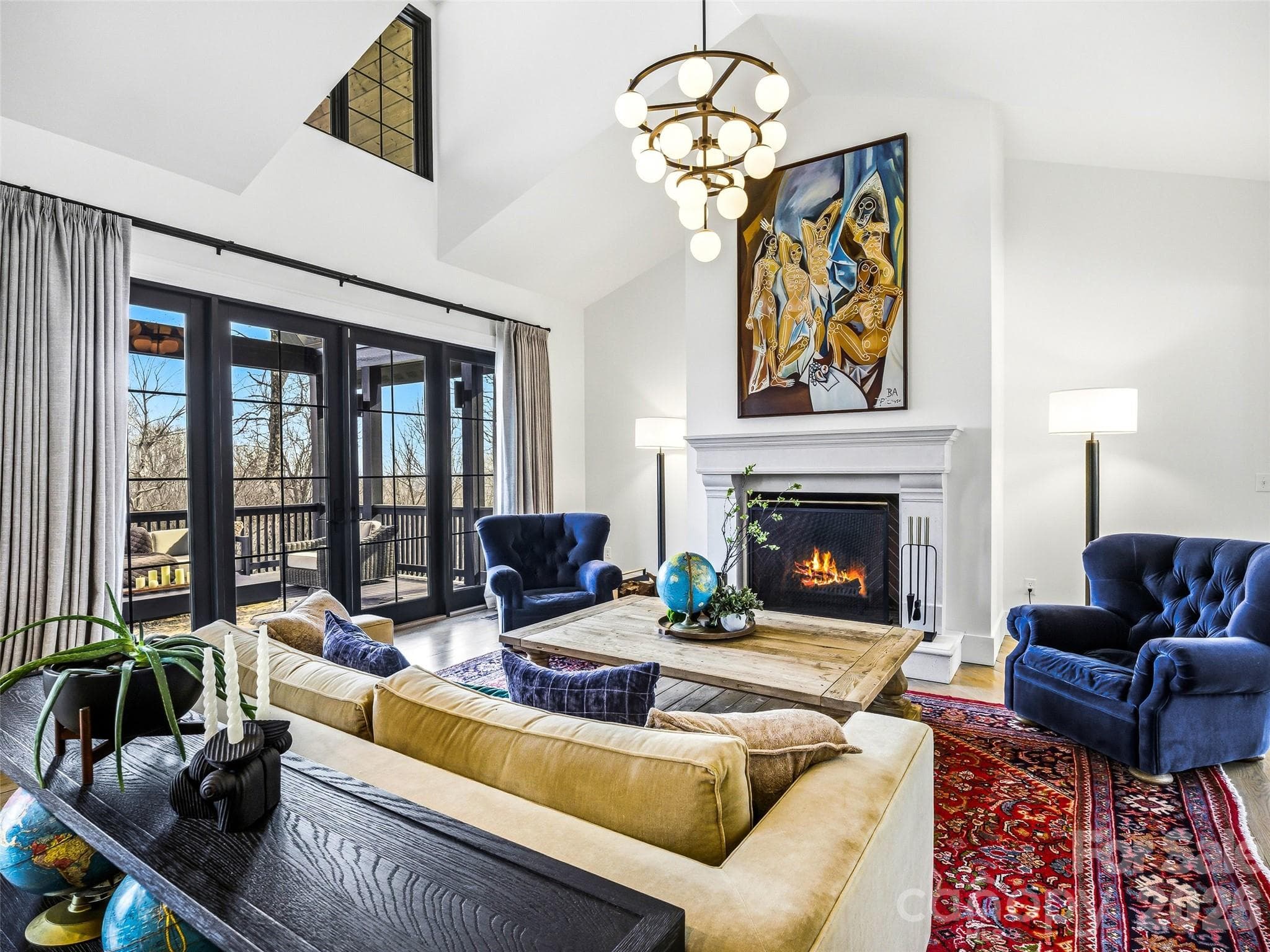 Floor-to-ceiling windows and French doors open to the covered deck for seamless indoor-outdoor living. - 241 Tower Circle, Hendersonville
