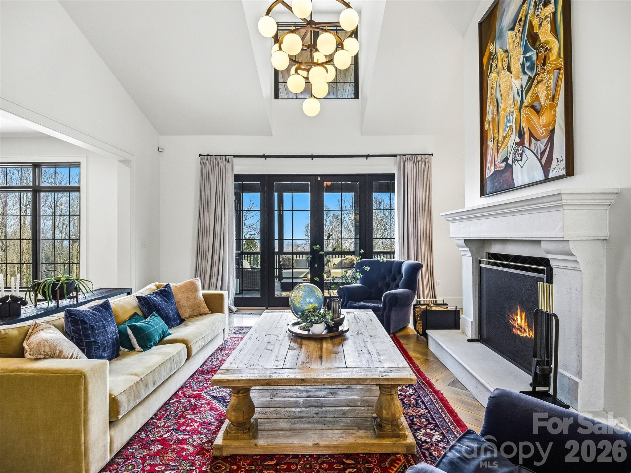 Bright living space with fireplace, hardwood floors, and elevated architectural details - 241 Tower Circle, Hendersonville