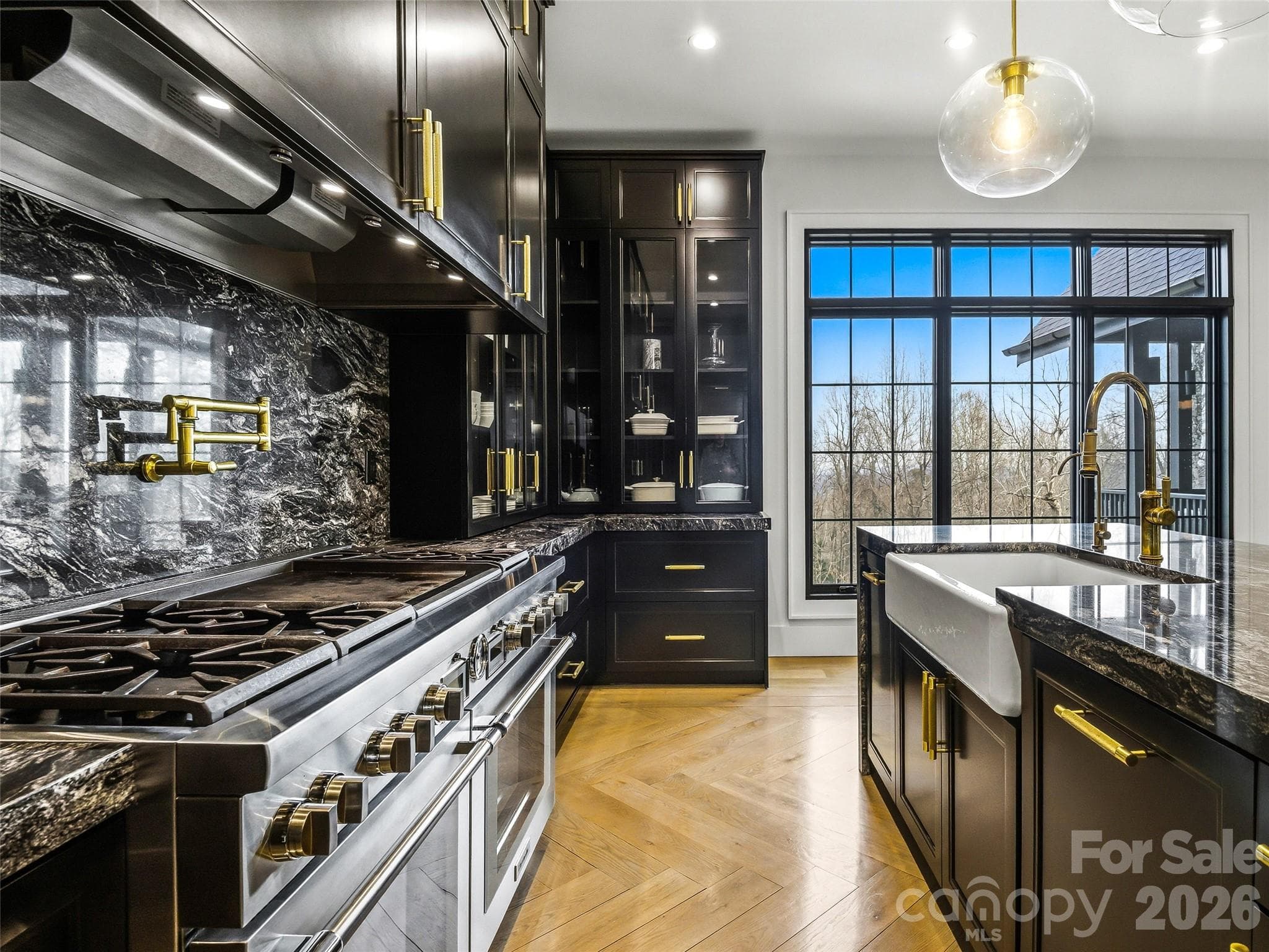 Chef’s kitchen with professional-grade range, granite surfaces, and custom storage throughout - 241 Tower Circle, Hendersonville