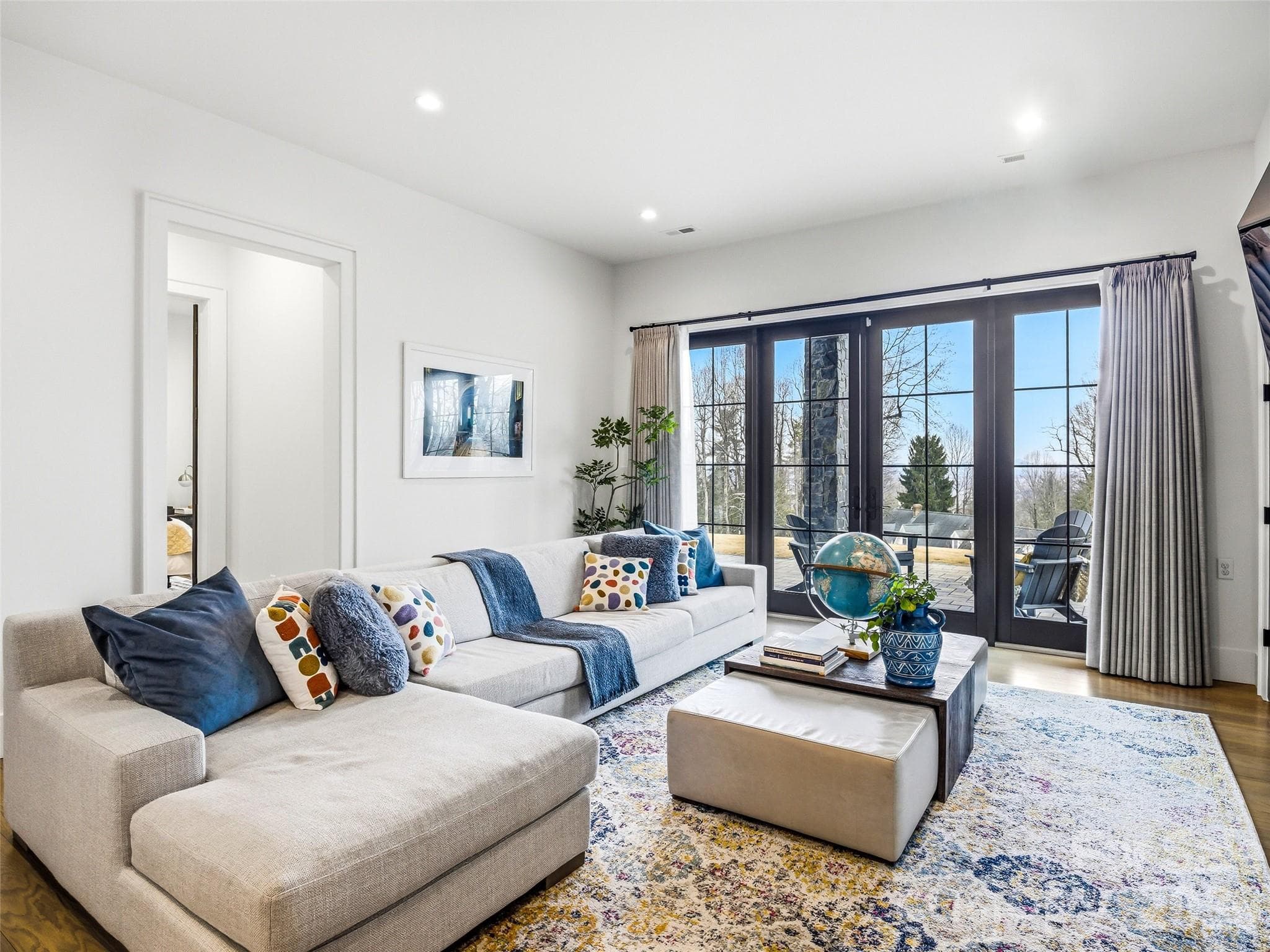 Lower-level living area with comfortable seating and access to outdoor patio - 241 Tower Circle, Hendersonville