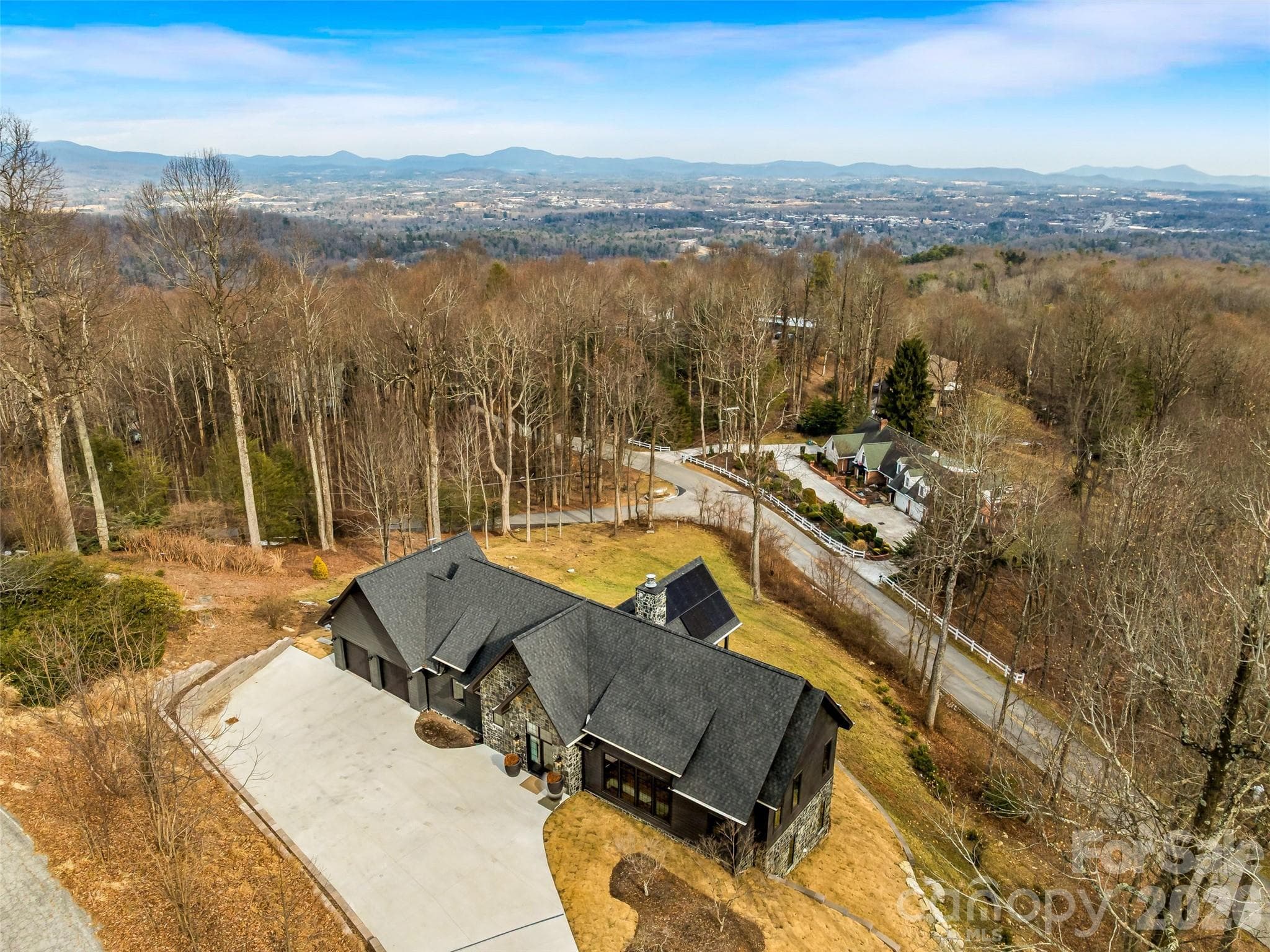 Panoramic aerial capturing mountain views and private wooded setting - 241 Tower Circle, Hendersonville