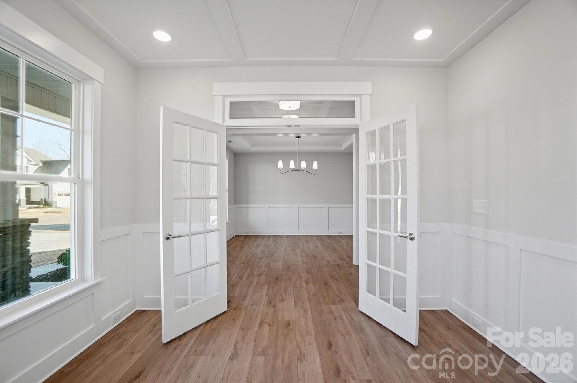 Office with faux coffered ceiling, French doors, and wainscoting - 5054 McLaughlin Loop, Waxhaw