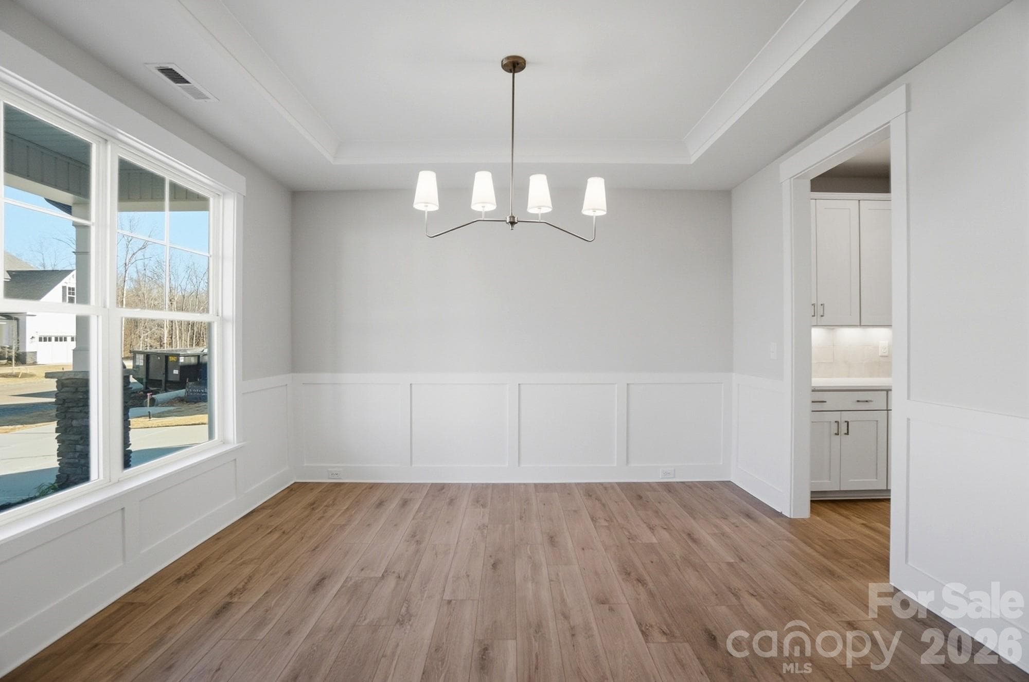 Dining room with Craftsman-style trim and tray ceiling - 5054 McLaughlin Loop, Waxhaw