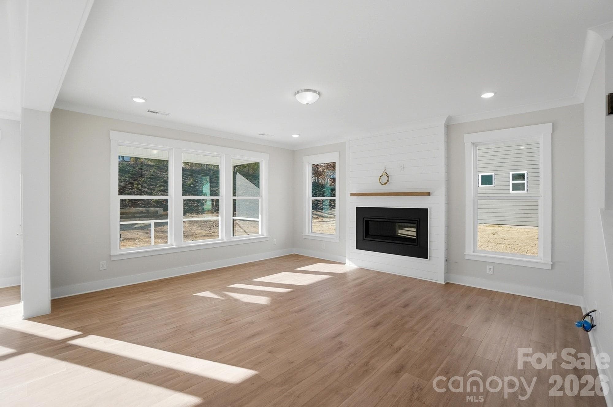 Family room with Cosmo fireplace and shiplap feature wall - 5054 McLaughlin Loop, Waxhaw