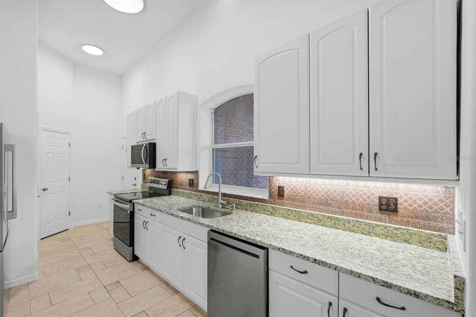 Kitchen with new counter tops and appliances. - 5941 MARVILLE CIR, PORT ORANGE