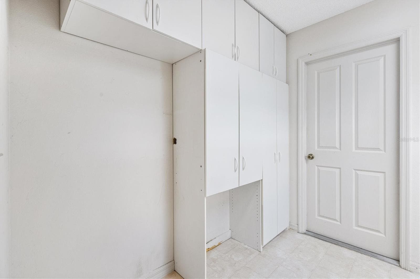 Laundry room with built-in cabinets for added storage - 17723 SE 81ST TIMBERWOOD TERRACE, THE VILLAGES