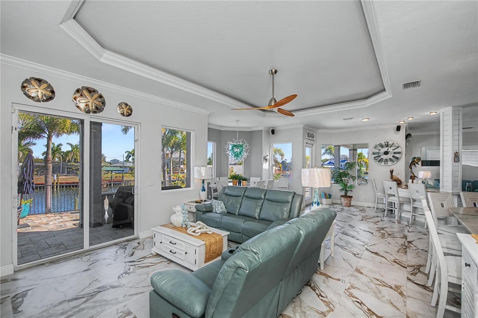 Family Room with Lighted Tray Ceiling, Views Down Canal and Dinette Area - 290 TAIT TER SE, PORT CHARLOTTE