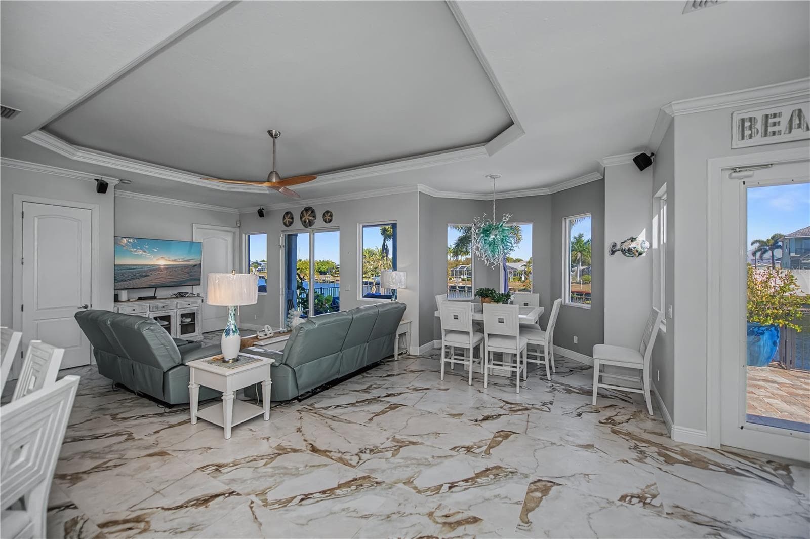 Family Room with Lighted Tray Ceiling, Views Down Canal and Dinette Area - 290 TAIT TER SE, PORT CHARLOTTE