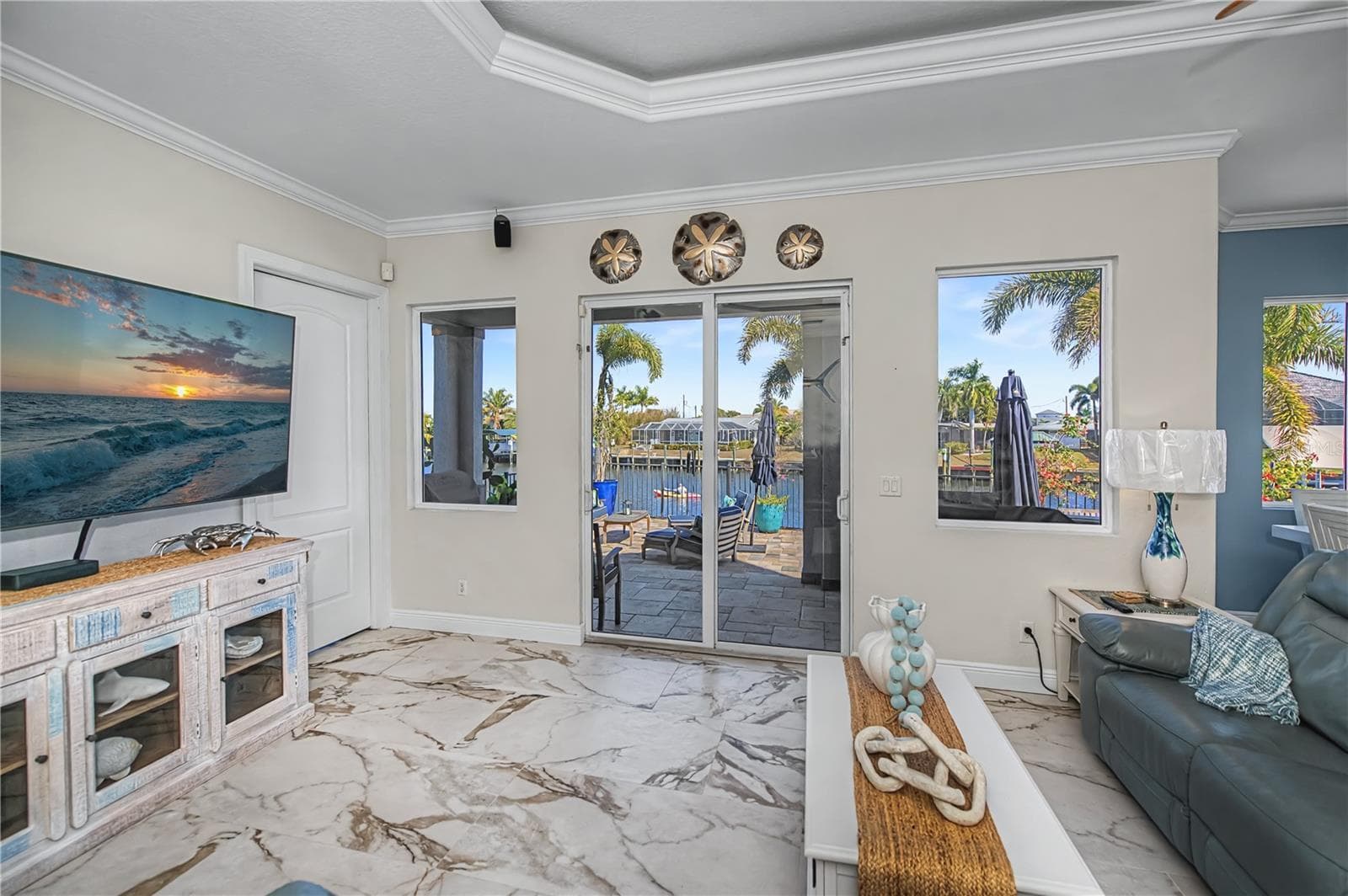 Family Room with Lighted Tray Ceiling, Views Down Canal and Dinette Area - 290 TAIT TER SE, PORT CHARLOTTE