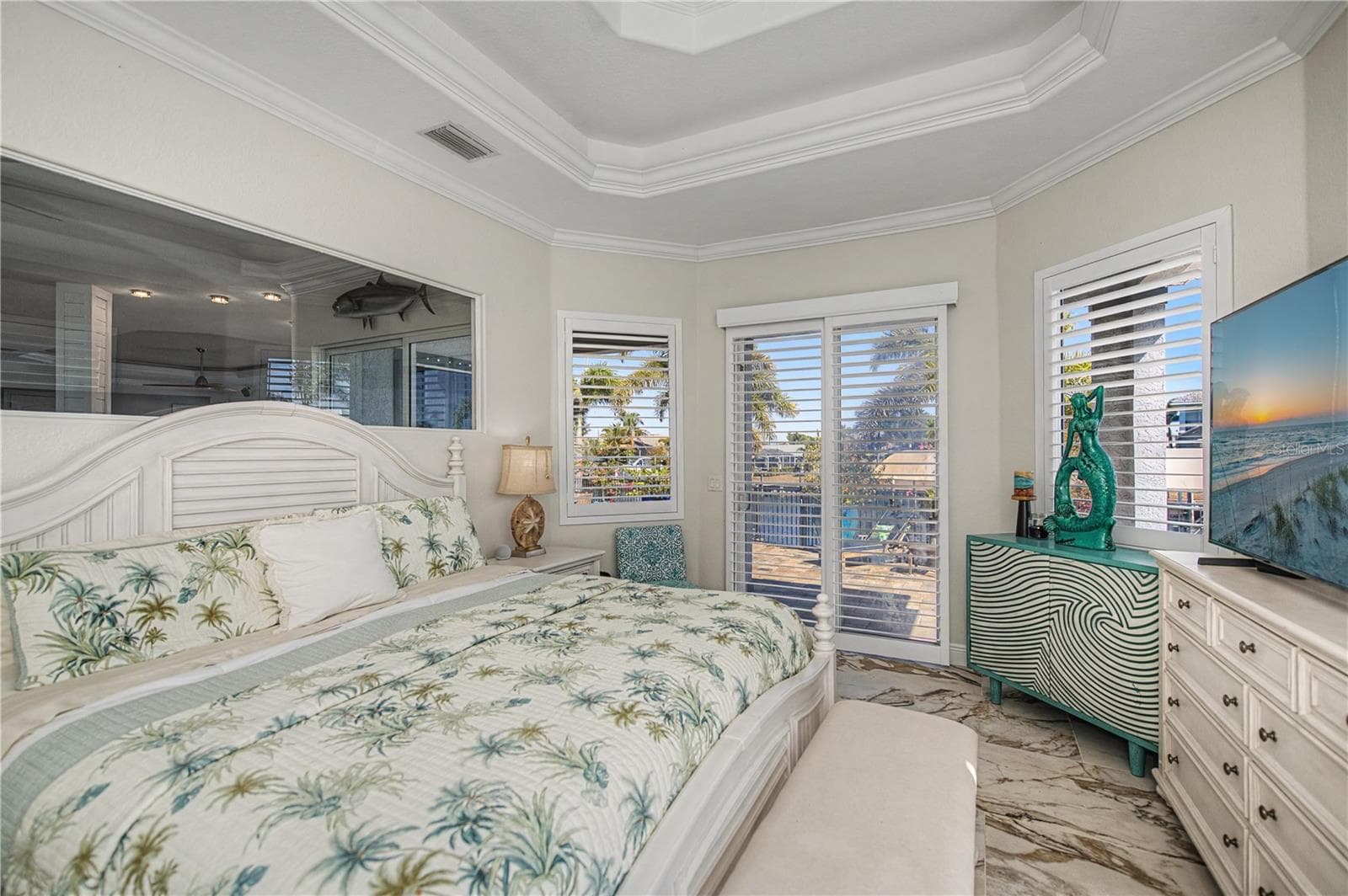 Primary Bedroom First Floor with Pool Access, Views down the Harbor, Two Walk in Closets and Luxurious On Suite Bathroom - 290 TAIT TER SE, PORT CHARLOTTE