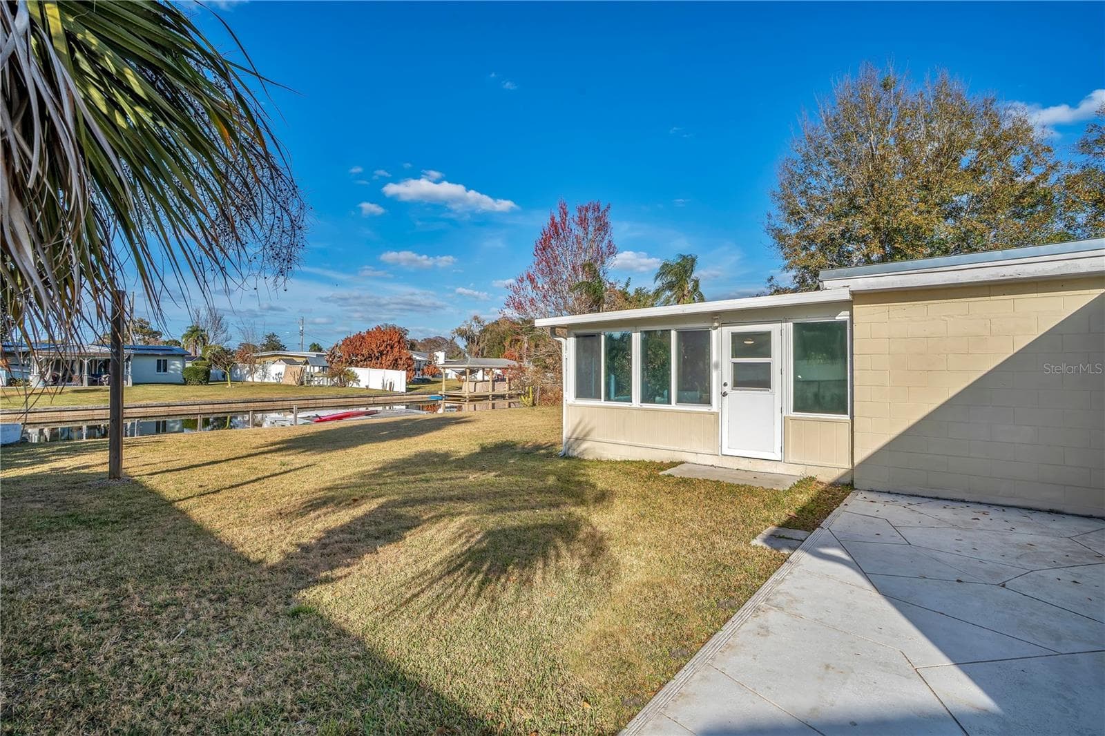 Back deck outside primary bathroom with canal view and view of bonus room door. - 2801 GULFSTREAM RD, ORLANDO