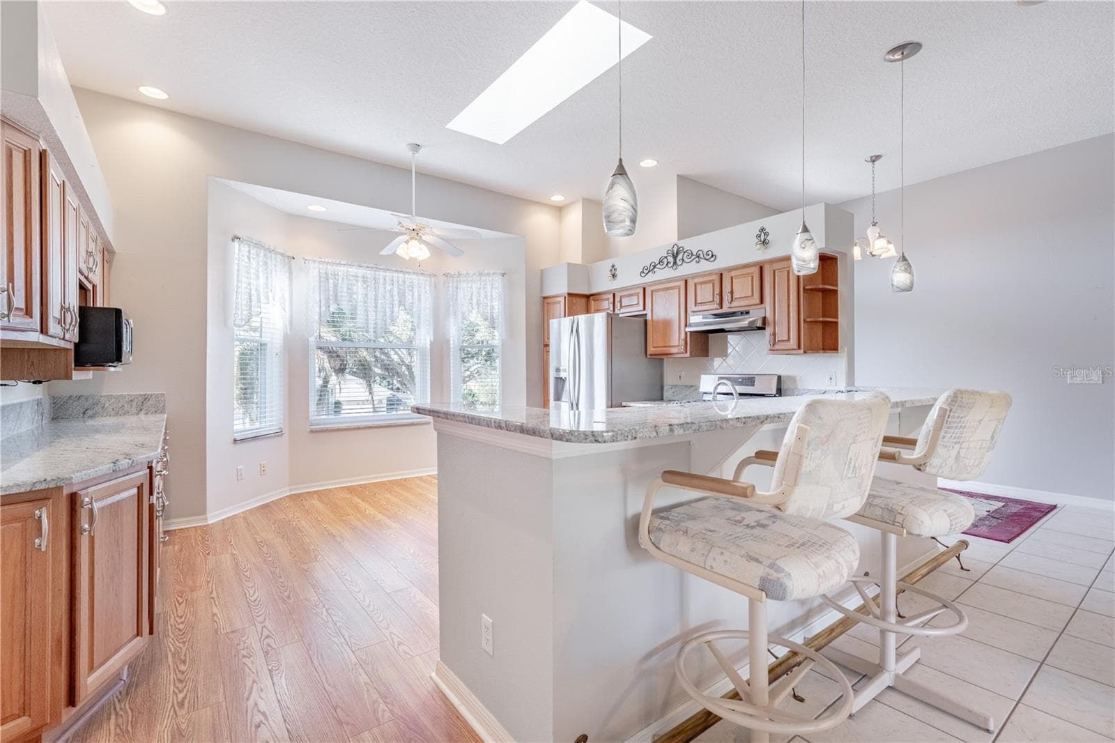 Kitchen with brass footrest at counter - 5732 FREEPORT DR, TAVARES