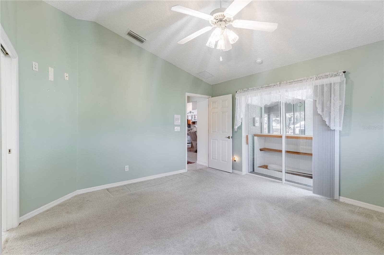 Primary bedroom with slider to Florida Room - 5732 FREEPORT DR, TAVARES