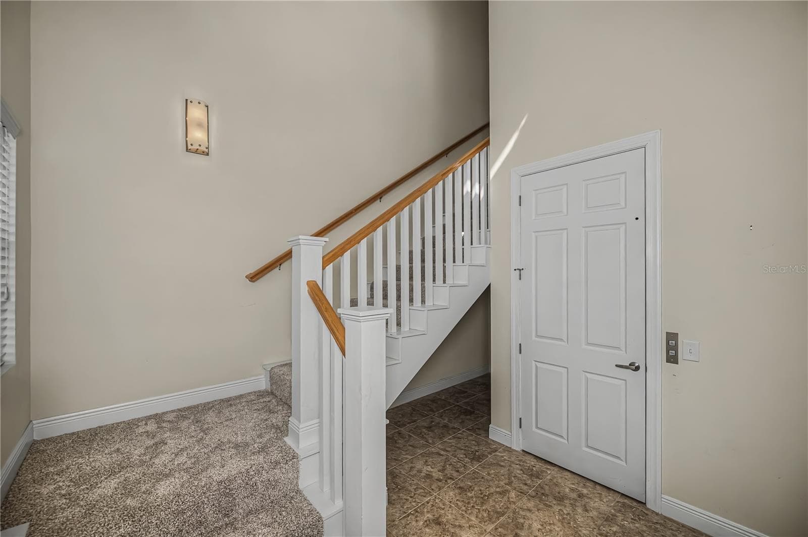 storage space below the turned staircase and private elevator door - 25601 HERITAGE LAKE BLVD #46, PUNTA GORDA