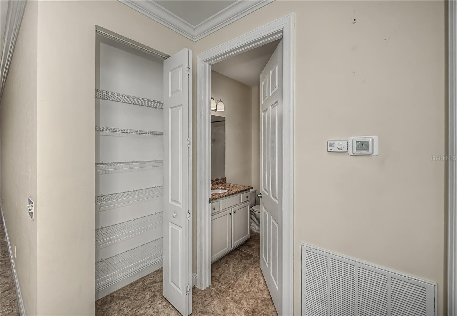 pantry and hall guest bathroom - 25601 HERITAGE LAKE BLVD #46, PUNTA GORDA