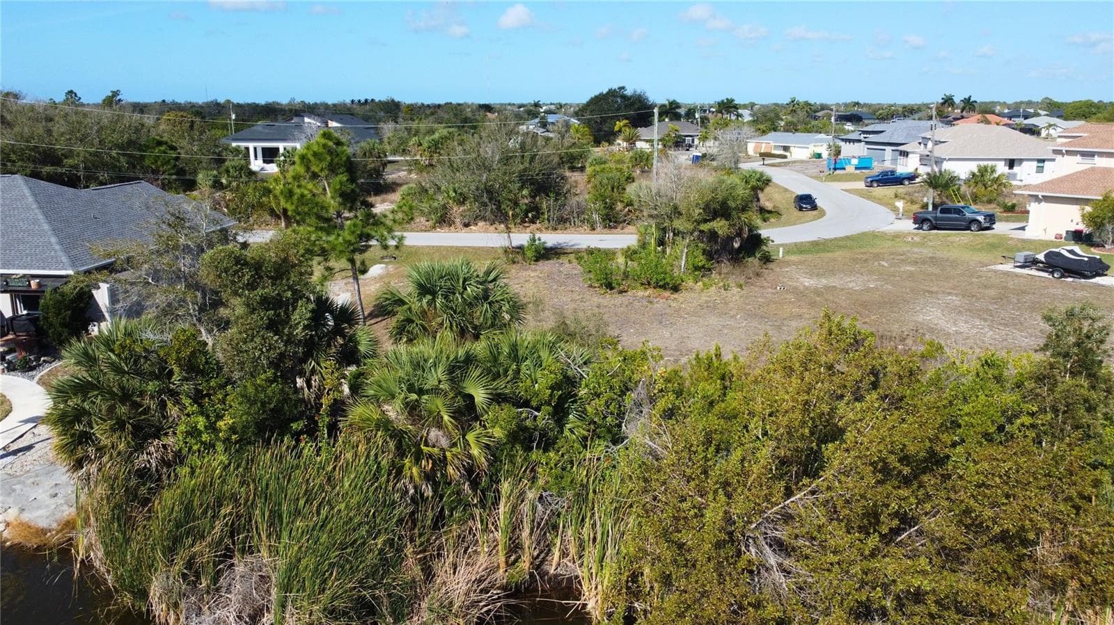 Aerial perspective of suburban area featuring a tree filled landscape - 9548 ATTICA CIR, PORT CHARLOTTE