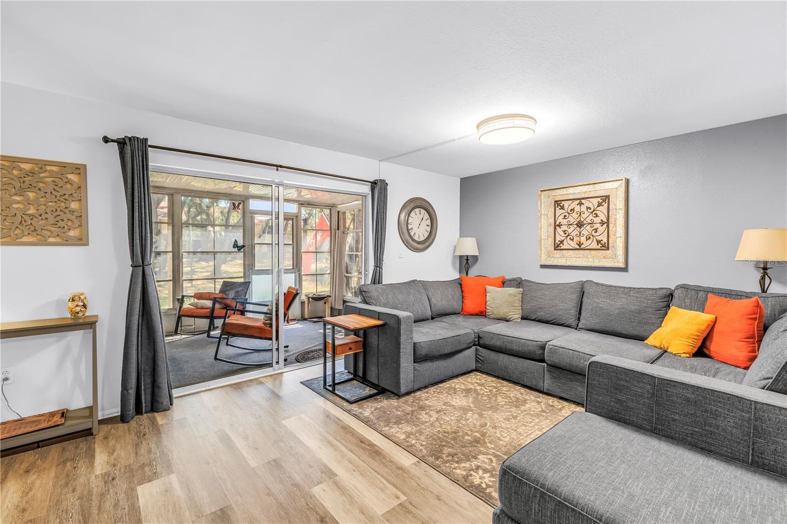 livingroom with sliders to bonus space and park - 3620 41ST WAY S #F, ST PETERSBURG