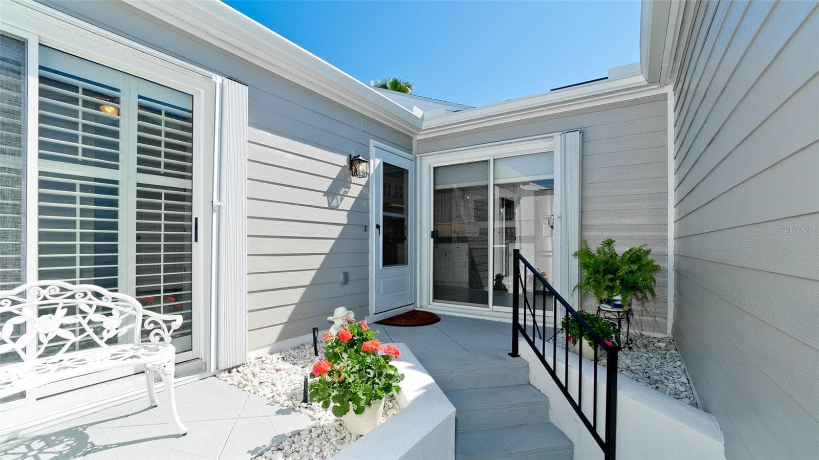 STORM SHUTTERS AT FRONT ENTRY & LANAI - 507 SANDERLING CIR, BRADENTON