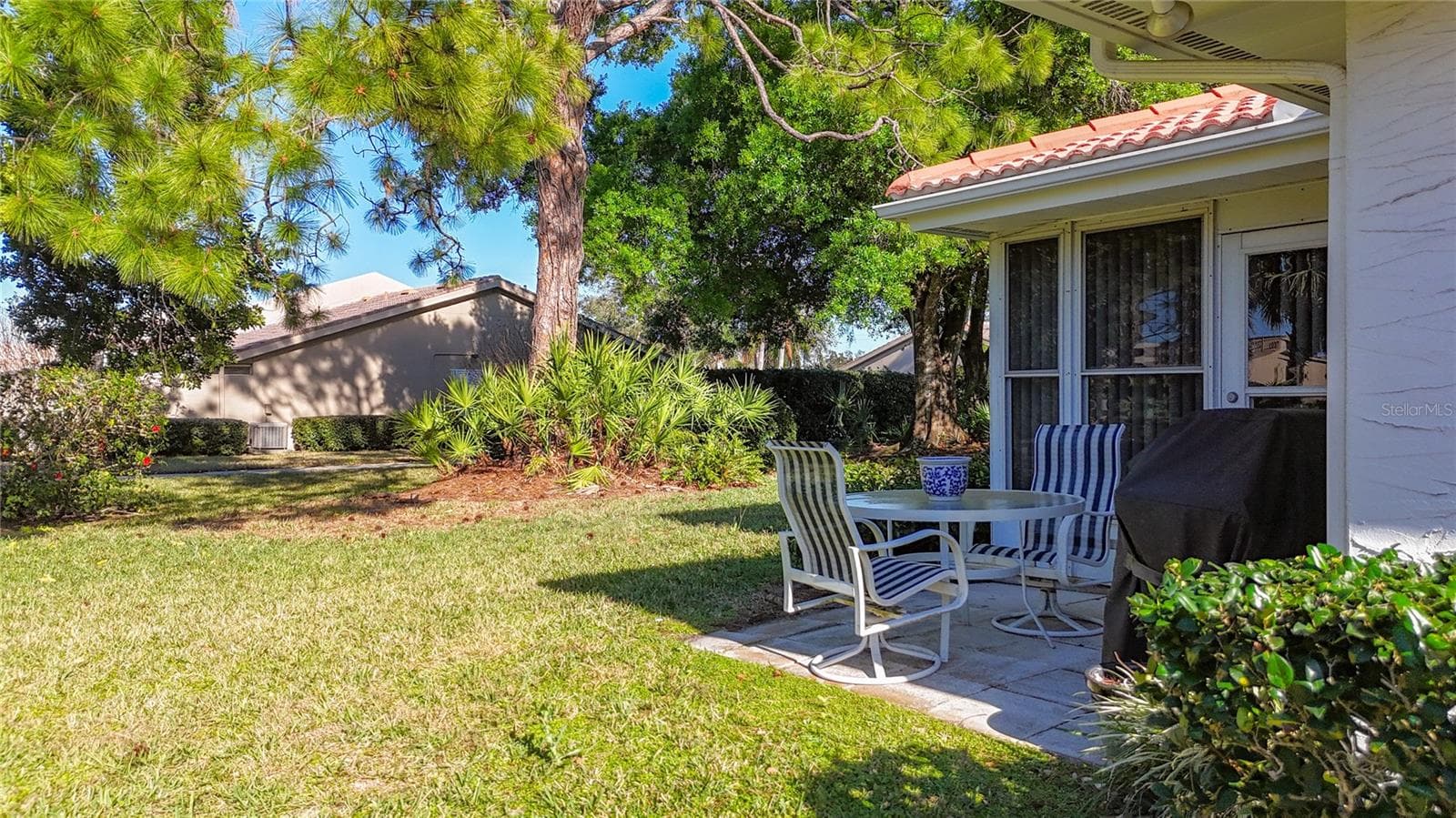 Open patio for grilling. Greenbelt view in the backyard with a walking trail. - 5611 GARDEN LAKES DR, BRADENTON