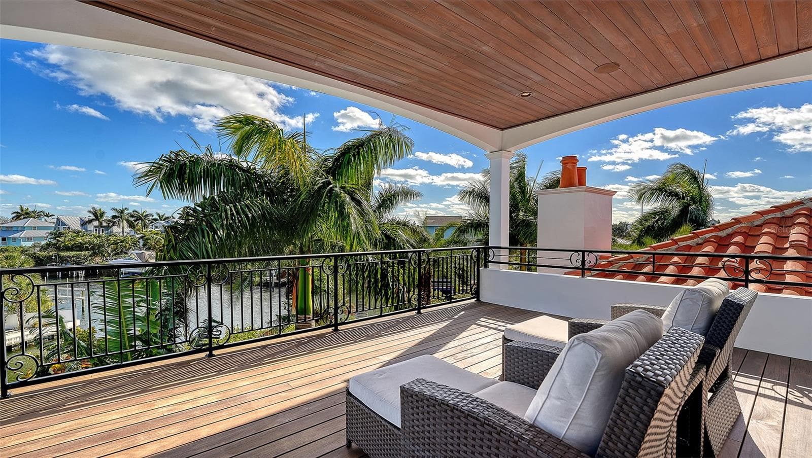 Covered terrace overlooking canal and palms - 513 VILLA ROSA WAY, ANNA MARIA