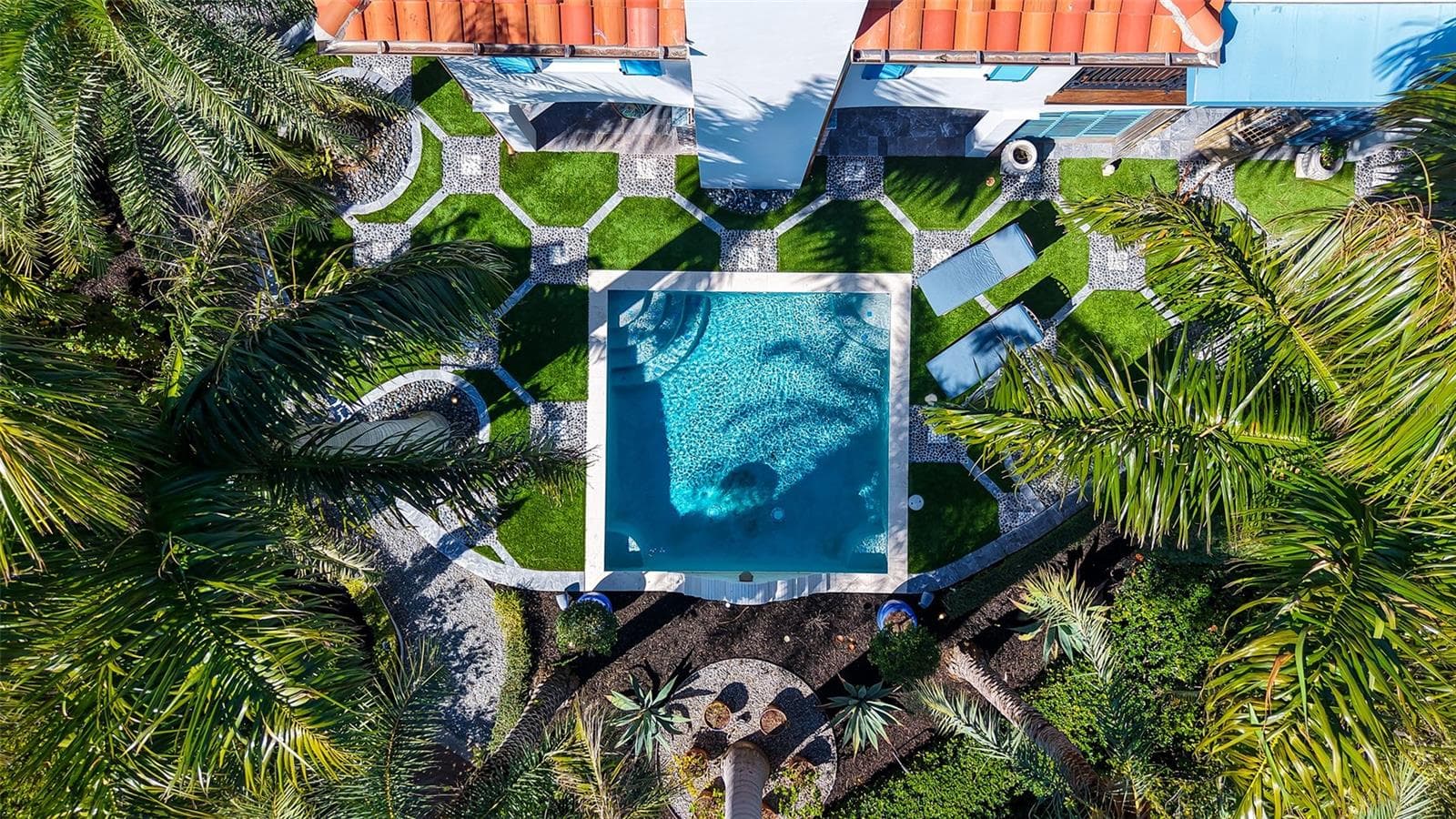 Resort-style pool surrounded by tropical landscaping - 513 VILLA ROSA WAY, ANNA MARIA