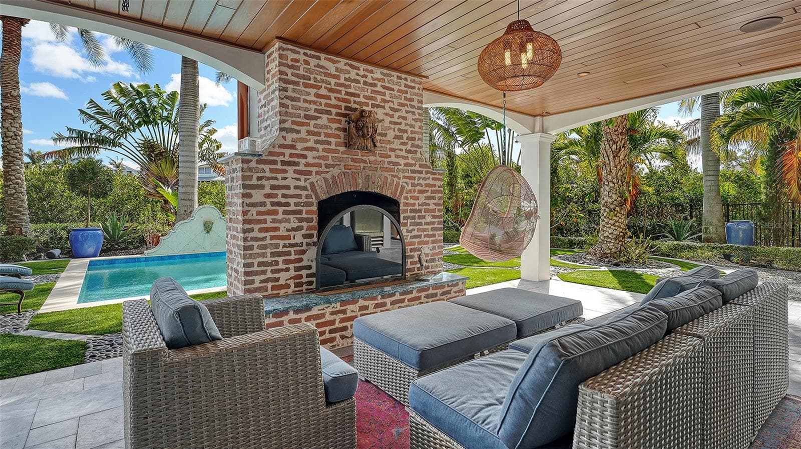 Outdoor living with wood-burning fireplace - 513 VILLA ROSA WAY, ANNA MARIA