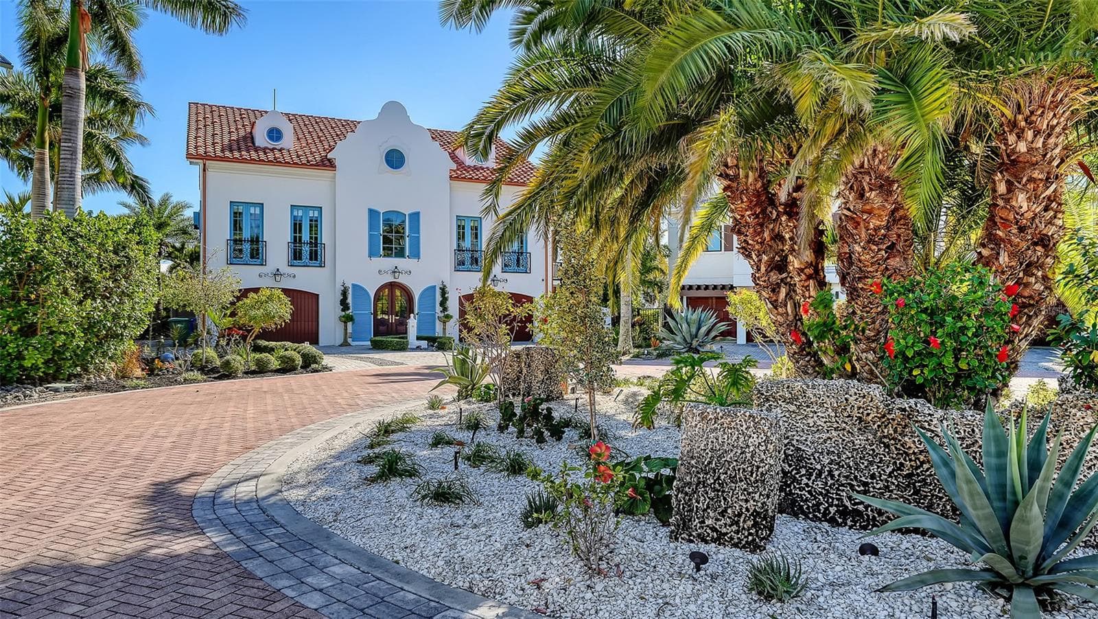 Grand arrival framed by tropical landscaping - 513 VILLA ROSA WAY, ANNA MARIA