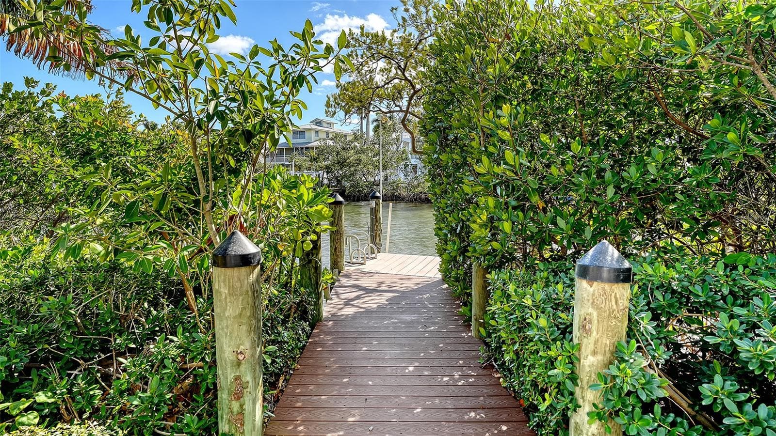 Private dock access through lush landscaping - 513 VILLA ROSA WAY, ANNA MARIA