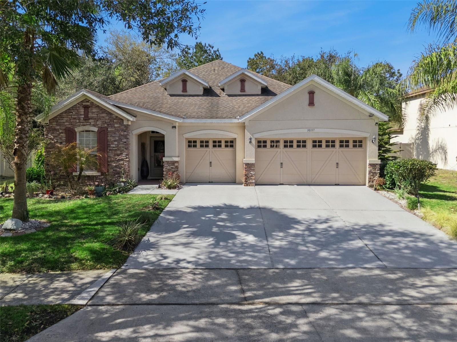Front exterior of Sullivan Ranch home with three-car garage - 30337 GIDRAN TER, MOUNT DORA