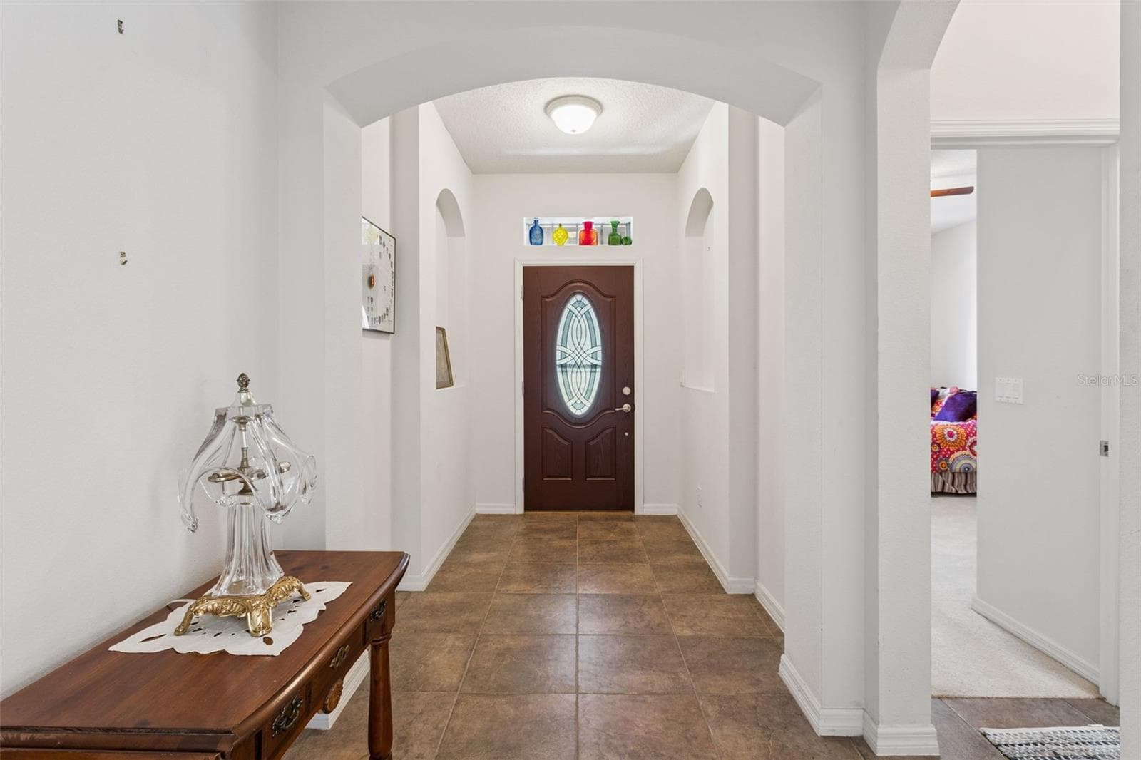 Hallway connecting front entry to primary living areas and bedrooms - 30337 GIDRAN TER, MOUNT DORA