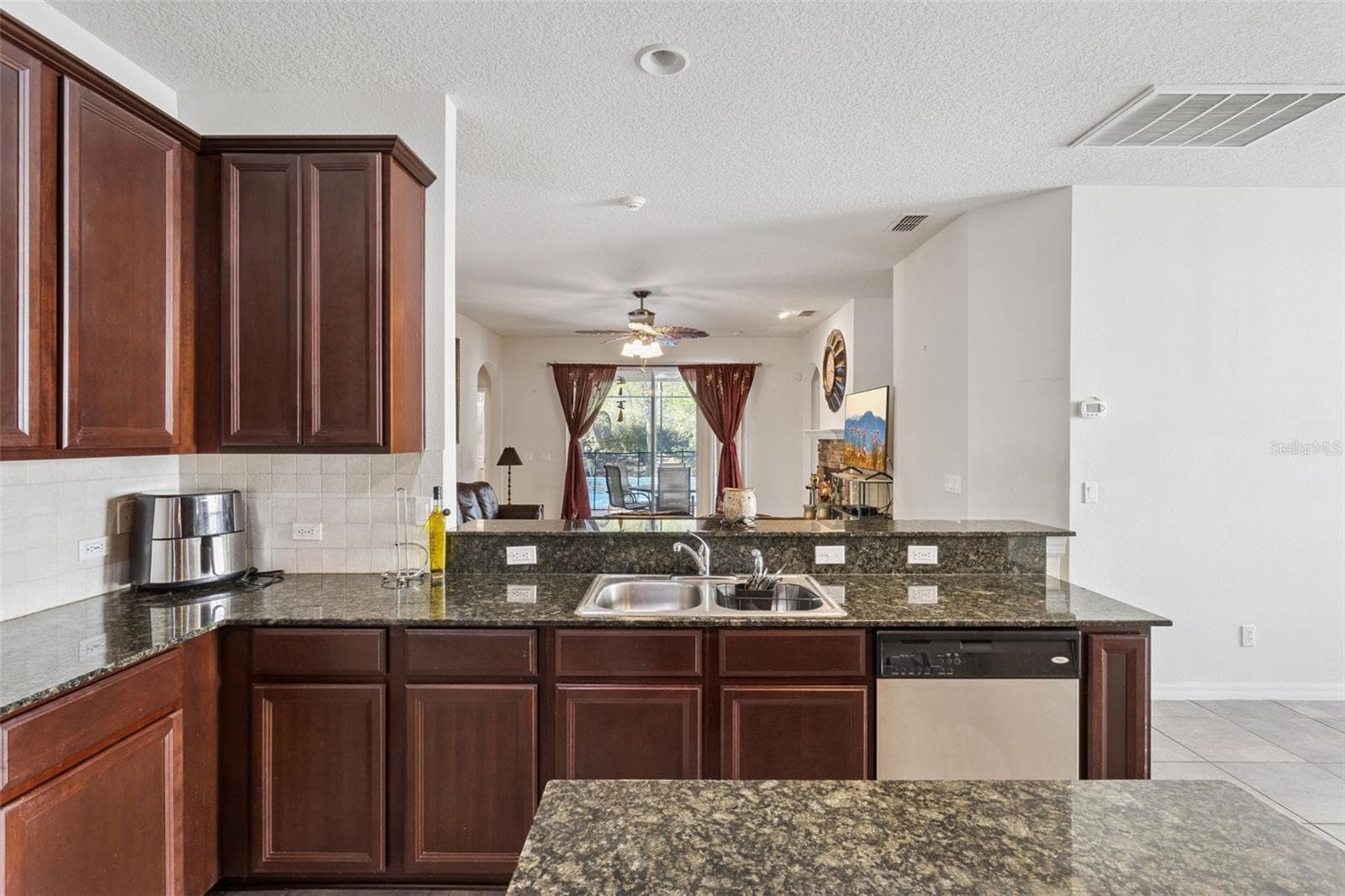 kitchen bar with views into living room - 30337 GIDRAN TER, MOUNT DORA