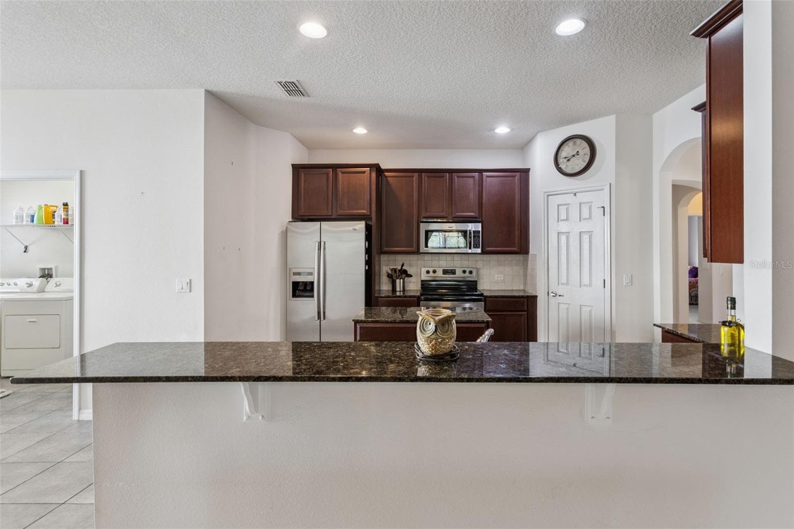 Granite countertops and cabinetry detail in kitchen - 30337 GIDRAN TER, MOUNT DORA