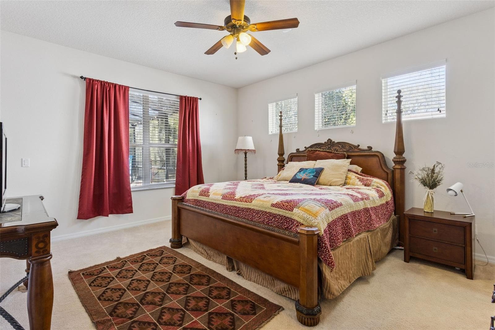 Primary bedroom with views toward the backyard and pool area - 30337 GIDRAN TER, MOUNT DORA
