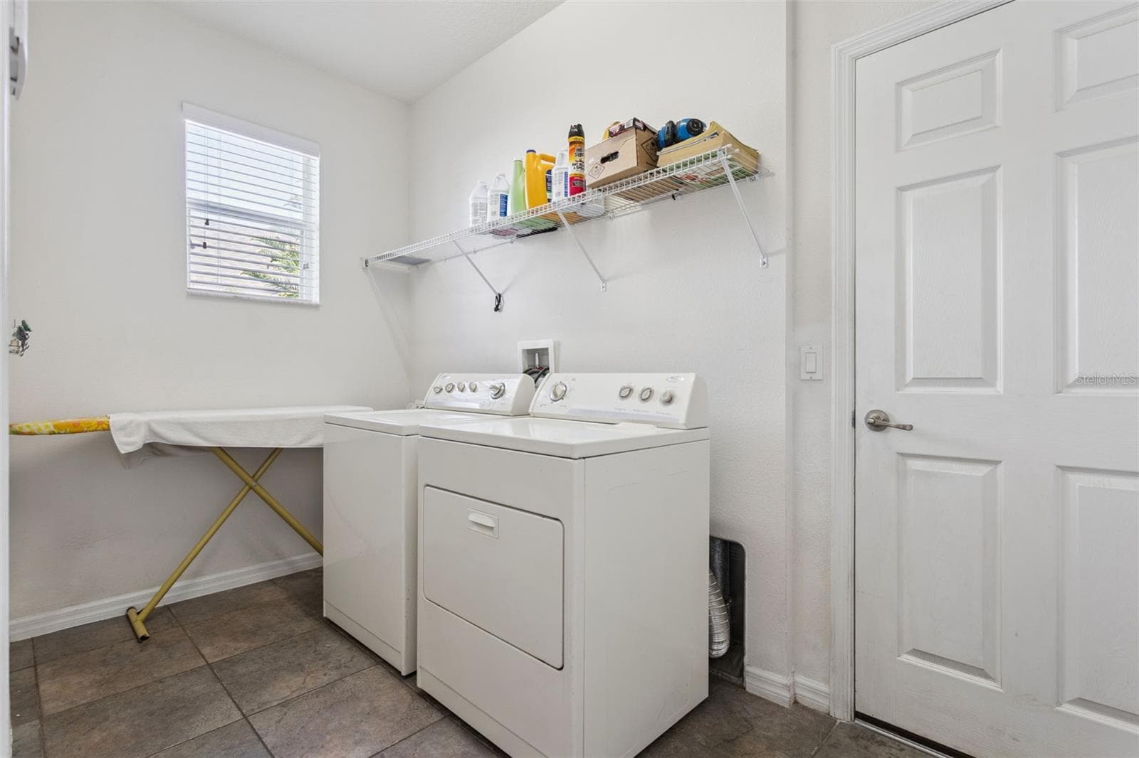 Interior laundry area with convenient access and storage space serving as a mud-room leading to garage. - 30337 GIDRAN TER, MOUNT DORA