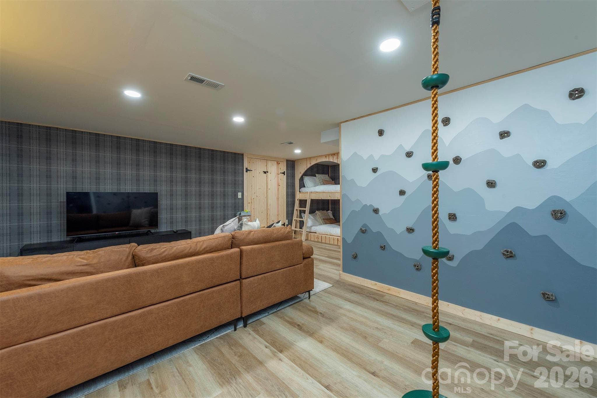 Adventure awaits indoors! The basement family room features a fun climbing wall and rope climb for kids (and adults!) to enjoy endless excitement. - Mars Hill