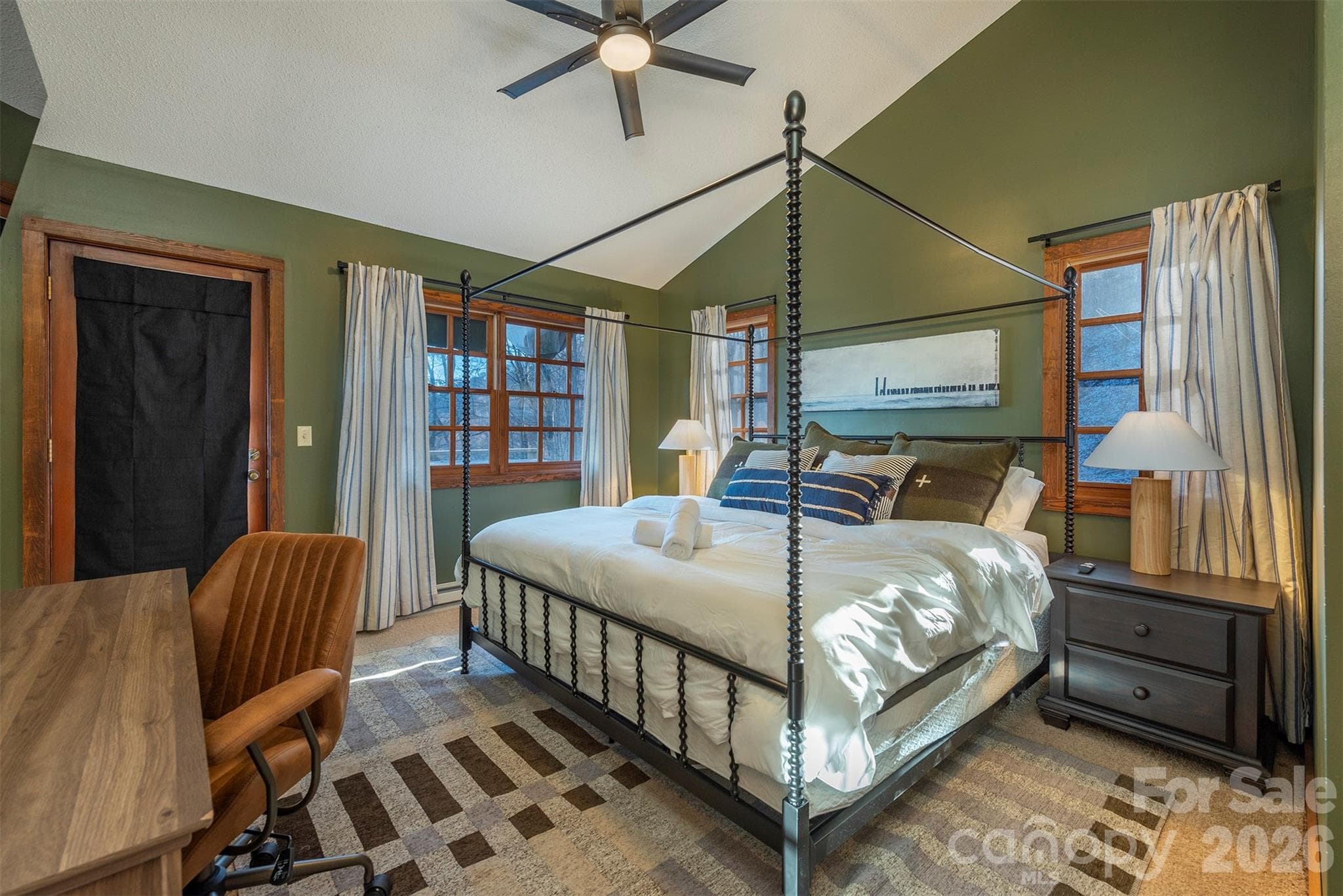 Main floor primary bedroom. Sleep in comfort on a luxurious king-sized bed, and stay productive with a dedicated workspace designed for your convenience. - Mars Hill