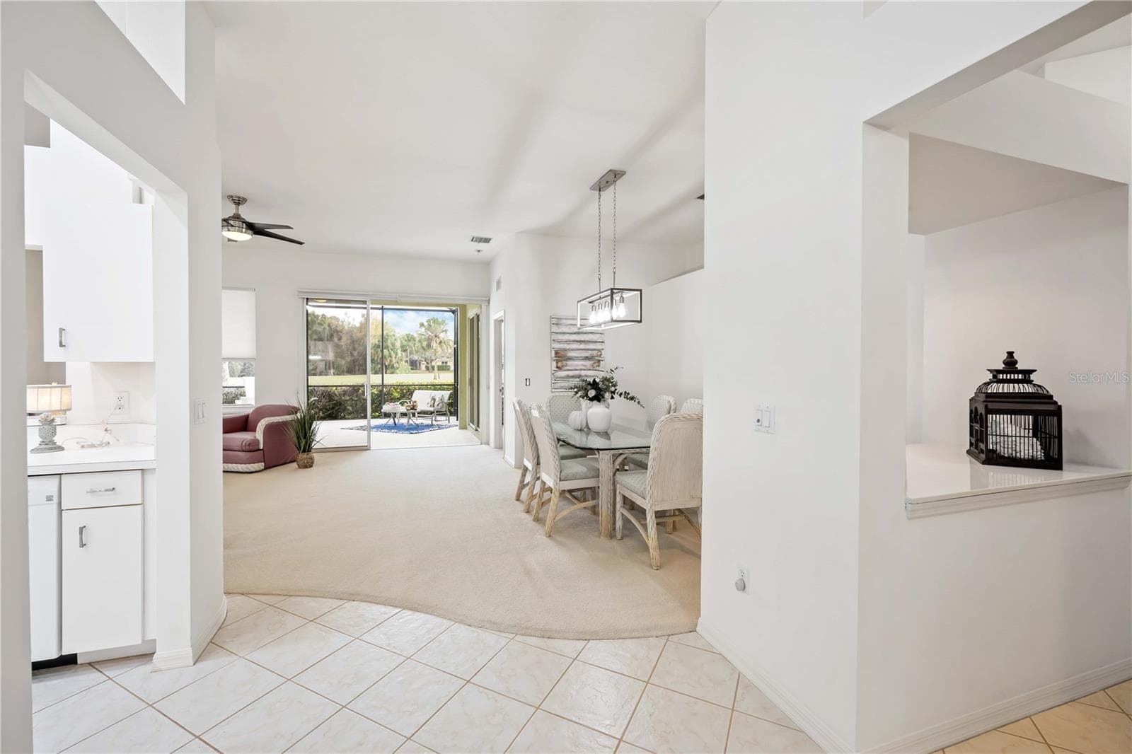 Kitchen on the left, dining room right, living room left and lanai overlooking the 12th fairway - 547 FALLBROOK DR, VENICE