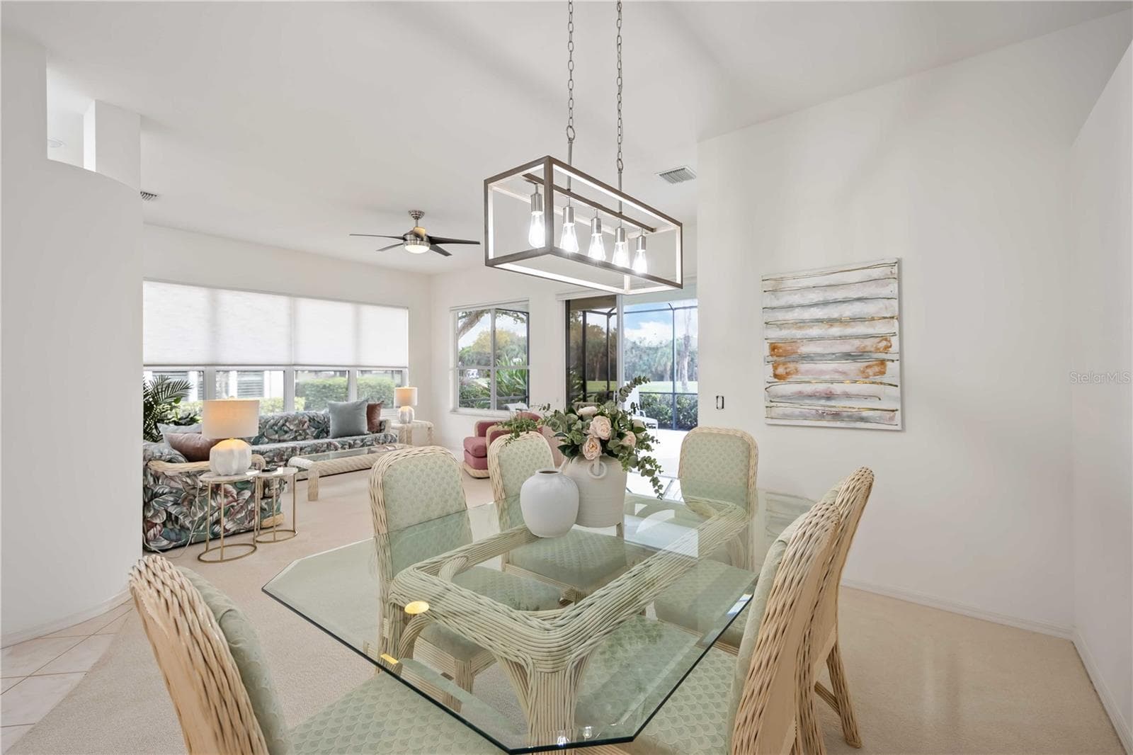 Dining Room to living room.  All furniture included.  Staging is available to be purchased. - 547 FALLBROOK DR, VENICE