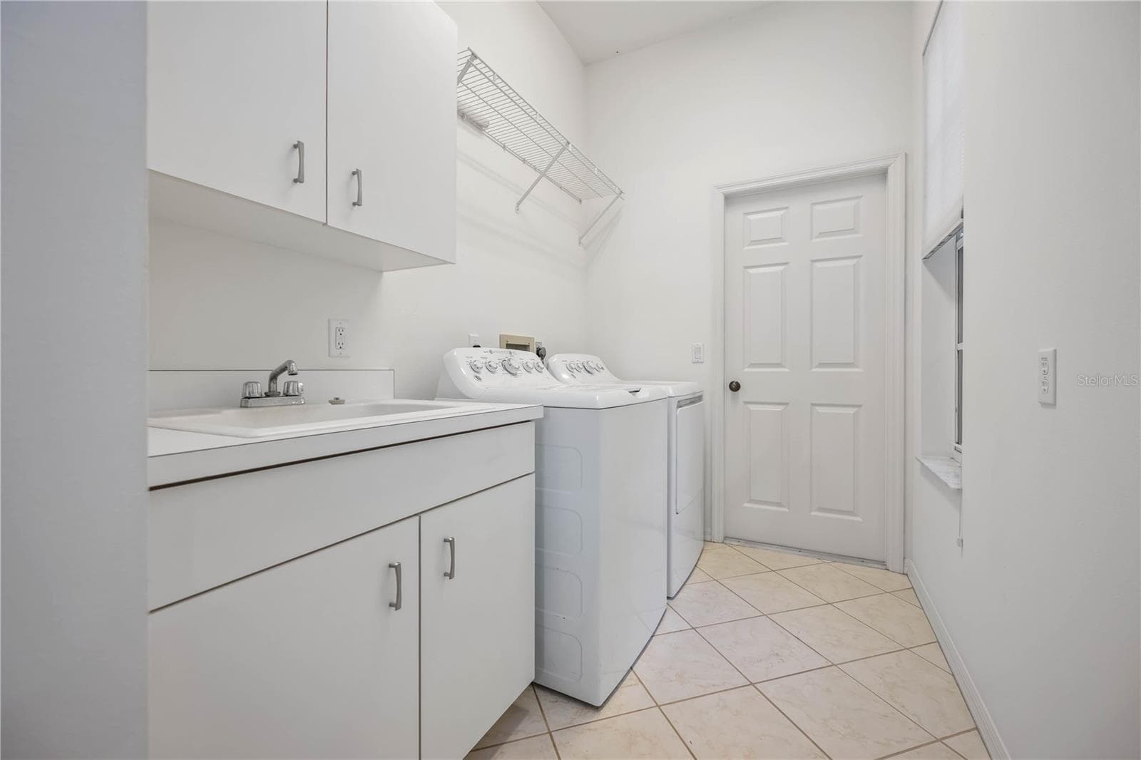 Laundry room and entry to garage - 547 FALLBROOK DR, VENICE
