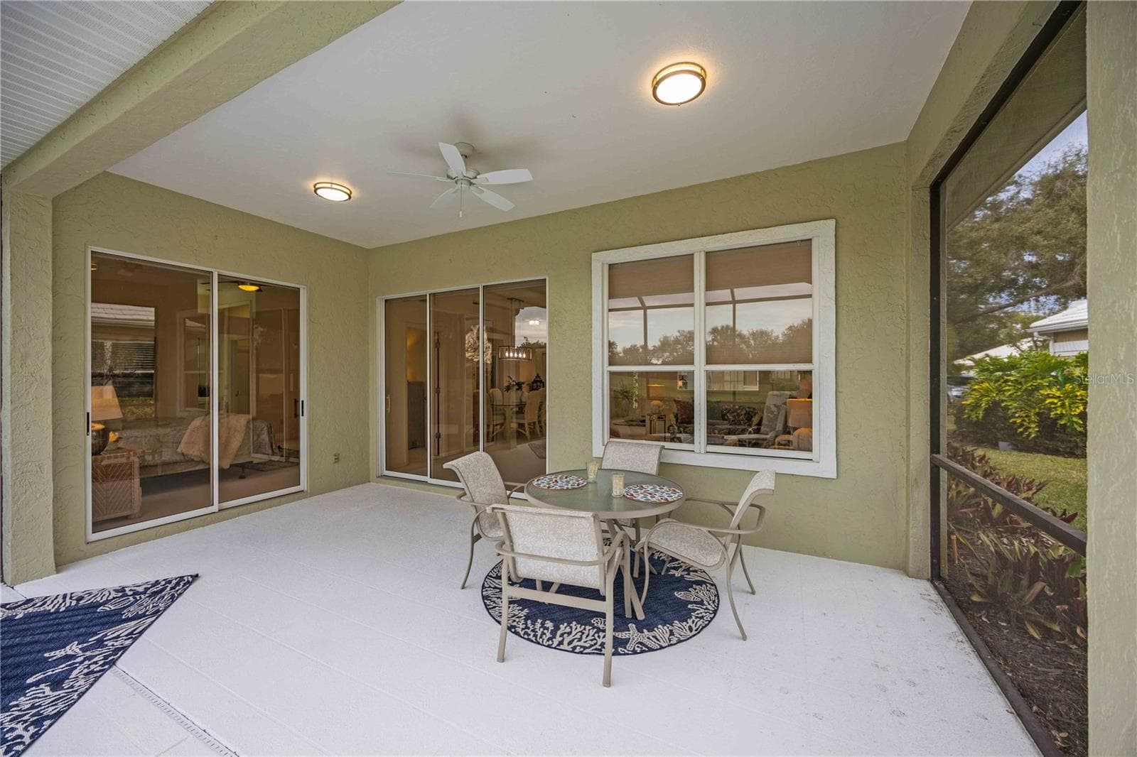 Sliding glass doors from lanai to the living room and primary bedroom - 547 FALLBROOK DR, VENICE