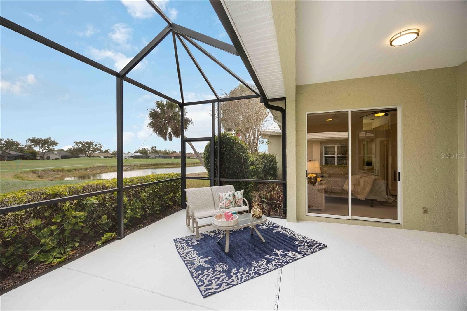 Sliding glass doors from lanai to the living room and primary bedroom - 547 FALLBROOK DR, VENICE