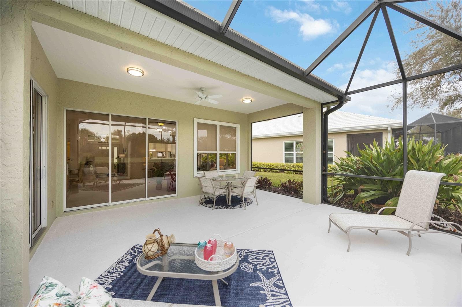 Sliding glass doors from lanai to the living room and primary bedroom - 547 FALLBROOK DR, VENICE