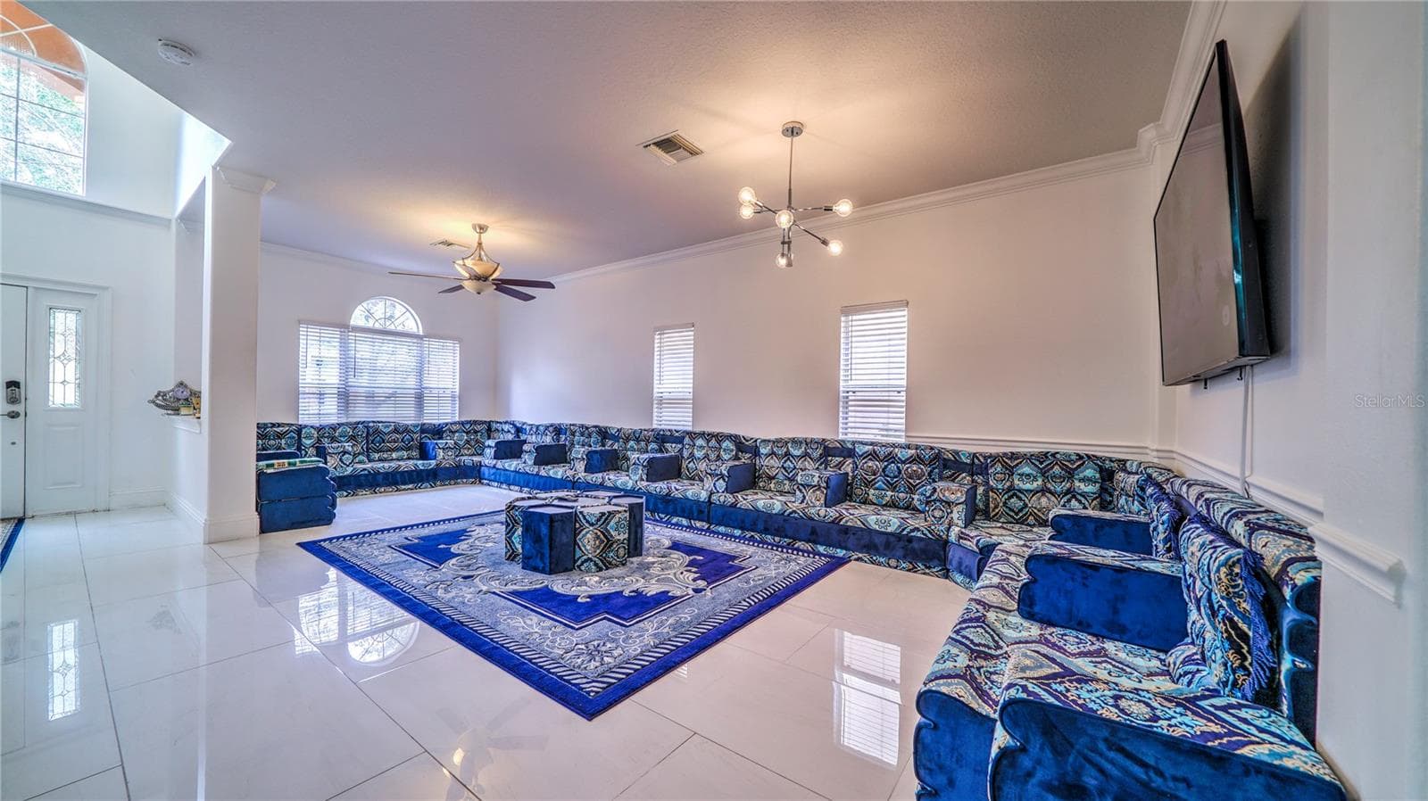 This living room is bright, spacious, and designed for both comfort and entertaining. - 6956 LUCCA ST, ORLANDO