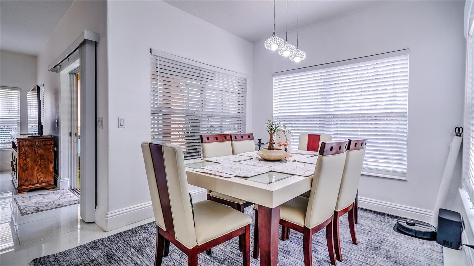 Dining room connected to the kitchen with a view of the pool area. - 6956 LUCCA ST, ORLANDO