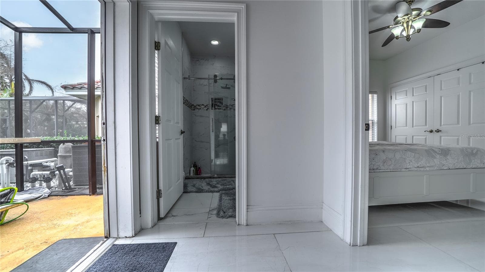First floor bedroom, bathroom, and access to the pool area. - 6956 LUCCA ST, ORLANDO