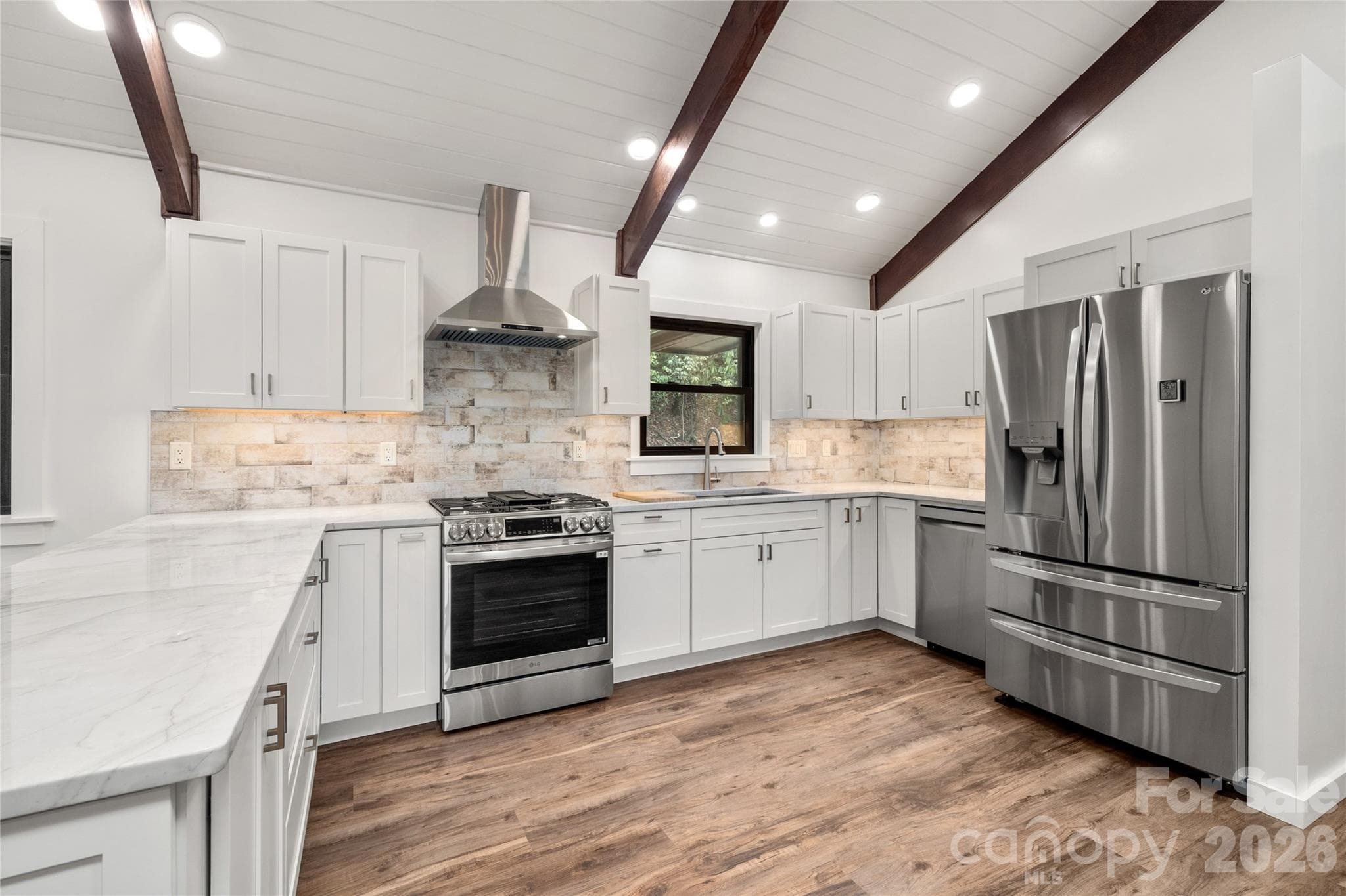 Updated kitchen with generous counter space and modern finishes. - Waynesville