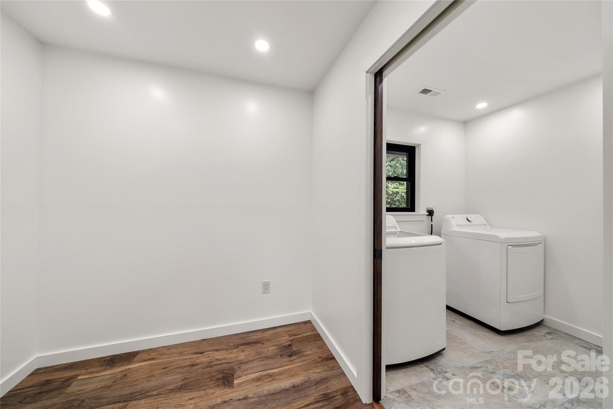Main-level laundry room with washer and dryer included. - Waynesville