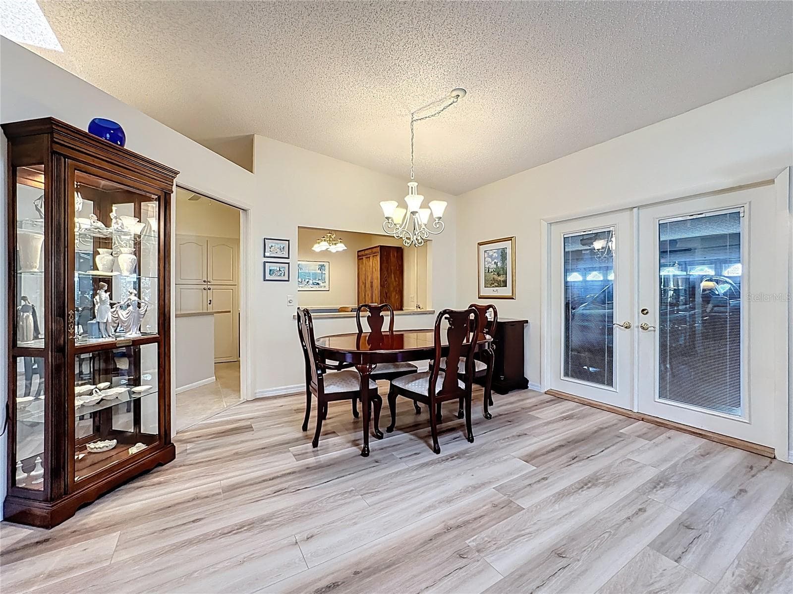 Dining room with French doors leading to garage. The openness adds convenience for moving large items. - 5611 GARDEN LAKES DR, BRADENTON