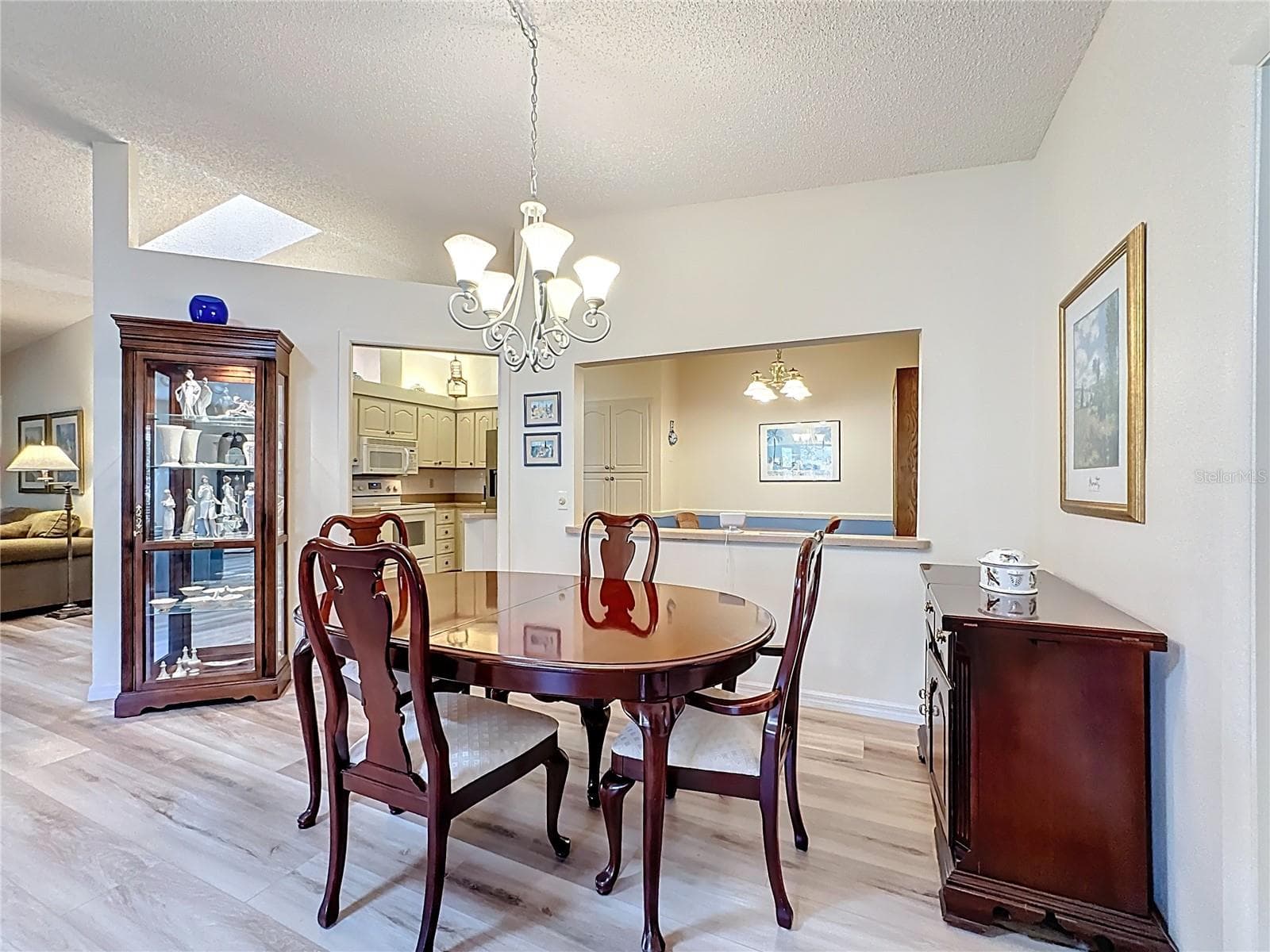 Dining room with views of kitchen and family room. - 5611 GARDEN LAKES DR, BRADENTON
